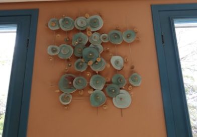 Wall art with circular elements on orange wall