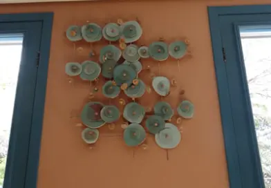 Wall art with circular elements on orange wall