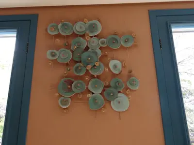 Wall art with circular elements on orange wall