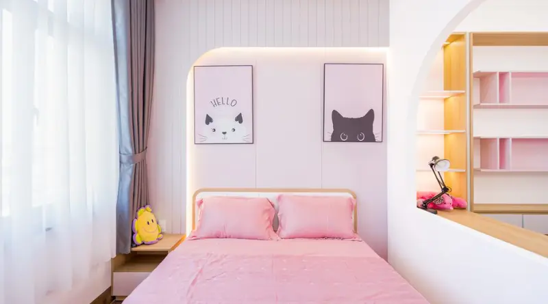 Bright bedroom interior with pink decor and playful cat art, perfect for a cheerful atmosphere.