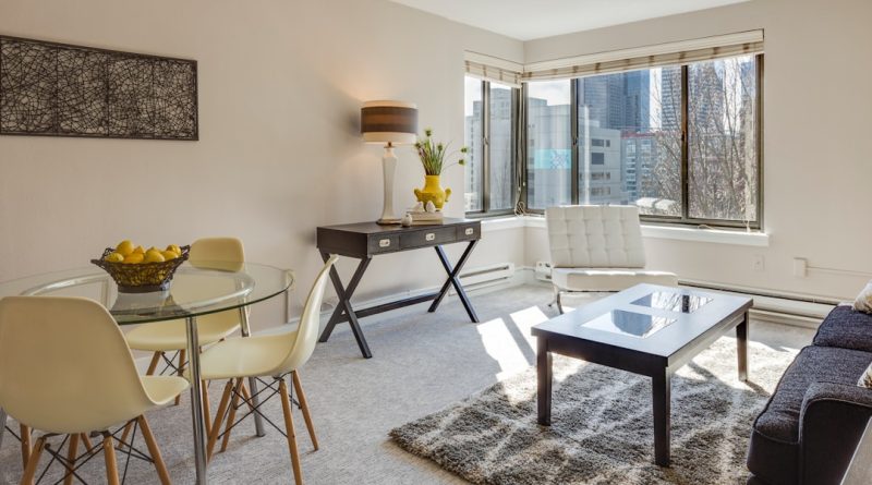 clear glass-top table and three chairs
