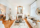 A cozy living room in Angers, France with a stylish fireplace and white furniture.
