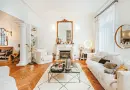 A cozy living room in Angers, France with a stylish fireplace and white furniture.