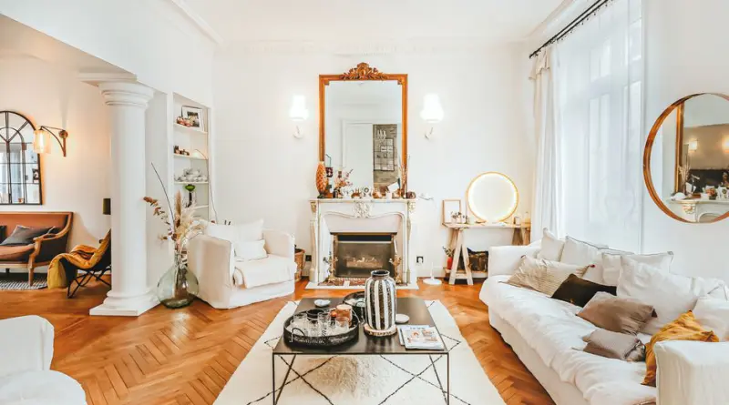 A cozy living room in Angers, France with a stylish fireplace and white furniture.